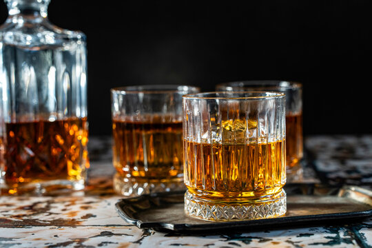 Bourbon in rocks glasses with a decanter 