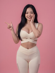 Fototapeta premium Smiling fitness woman posing in beige sportswear