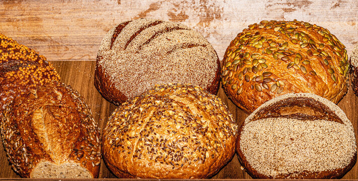 Wide selection of freshly baked bread loaves and rolls at a luxury hotel open buffet breakfast.