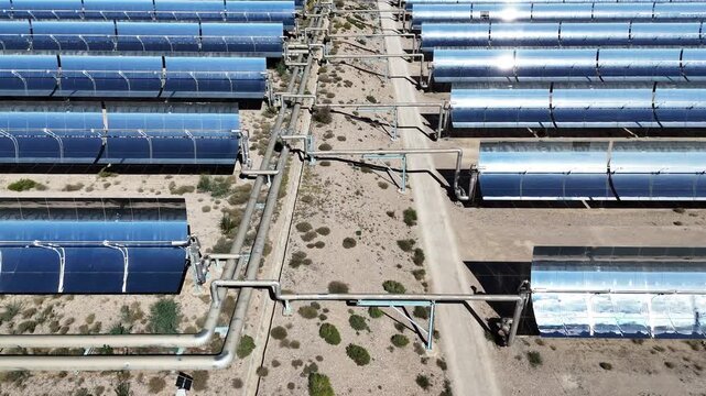 Cylindrical solar thermal power plant collector tube arrays in desert landscape