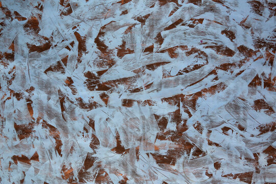 Abstract texture with layered white and brown brushstrokes. Pattern feels raw, energetic, and spontaneous. Suitable for modern design, art, or editorial backgrounds