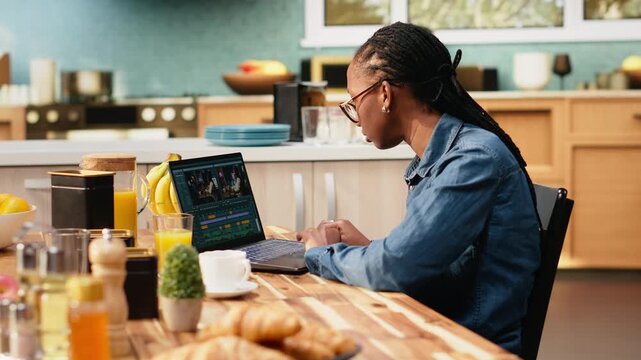 Content creator edits a video montage on a laptop with color grading, videography and post production techniques. Color correction and VFX tools support the creative process indoors.