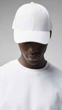 Blank White Baseball Cap Mockup Worn by Black Male Model in White T-Shirt
