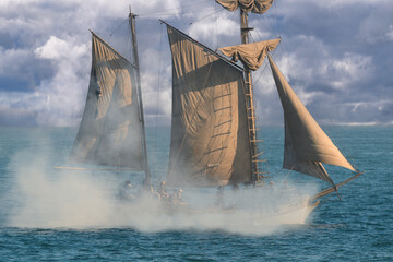Historic Sailing Vessel Firing a Cannon at Sea  © PixilRay