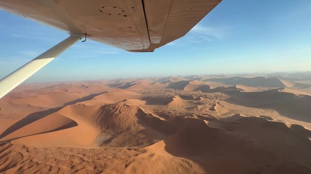 View from the plane over endless sand dunes of the Namib Desert, impressive desert landscape, sightseeing flight in the evening light, aerial view, Namib-Naukluft National Park, Namibia