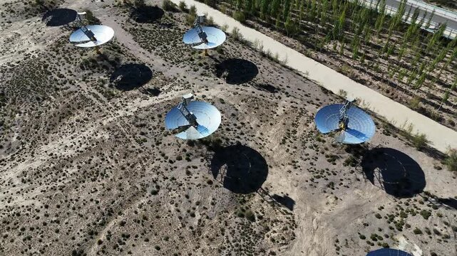 Rows of solar reflector mirrors in the desert landscape