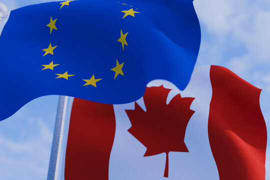 Close-up of European Union and Canadian flags waving together in the sky, representing international partnership, trade agreements, diplomatic alliance, and global cooperation.