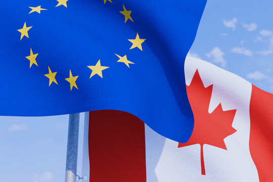 Close-up of European Union and Canadian flags waving together against a blue sky, symbolizing international trade, diplomatic alliance, economic partnership, and bilateral relations.