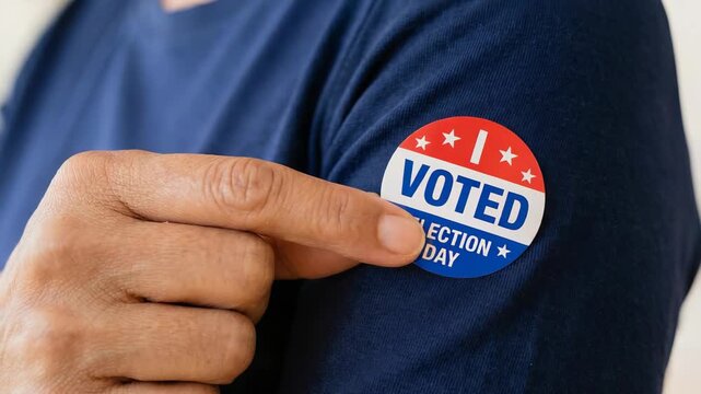 Man wearing American voted sticker on his shirt sleeve. Citizen showing pride in democracy by pointing at election badge. Civic duty participation during voting day