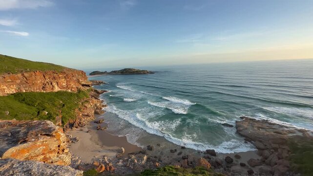 Picturesque coastal landscape, sea and sandy beach, view of The Gap at sunset, Robberg Nature Reserve, Plettenberg Bay, Garden Route, South Africa