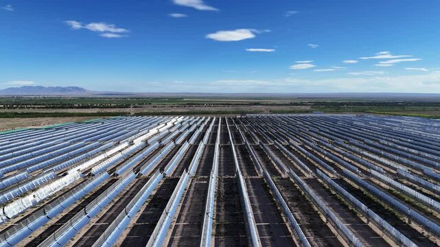Panoramic view of parabolic trough solar thermal power station in vast plains