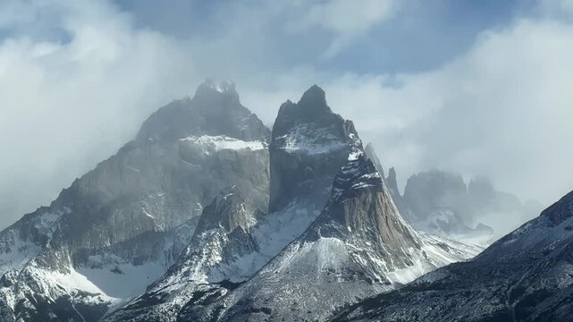 Clouds move over impressive mountain peaks, rocky peaks Cuerno Este and Cuerno Principal, time lapse, Torres del Paine National Park, Patagonia, Chile