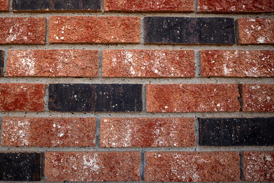Close detail of red and black brick wall