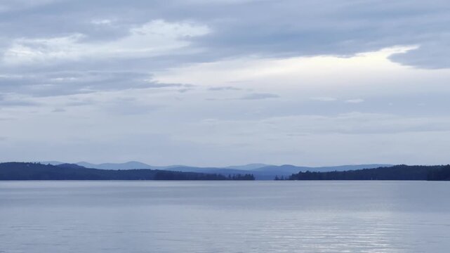 Serene Blue Lakescape: Water, Sky & Distant Blue Peaks