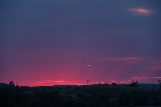Bright pink sunset with clouds and crepuscular rays