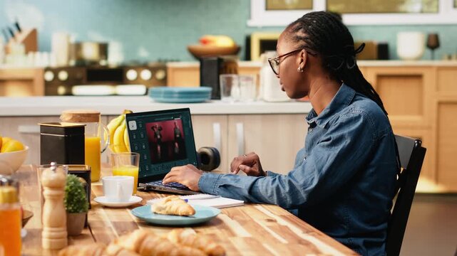 AI-powered application on a laptop generates images from text scripts using generative artificial intelligence and technology. Woman interacts with chatbot for productivity in everyday life at home.