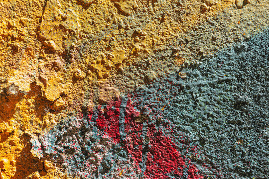 Urban palimpsest and intuitive harmony of chaos on rough wall abstract art texture with unconventional ochre blue and crimson combination industrial background