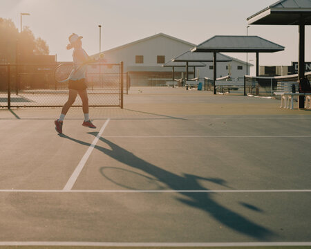 junior tennis player practising on court