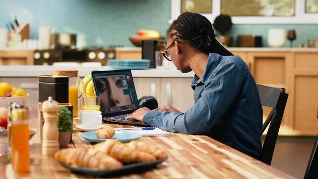 Woman graphic designer retouching photos on laptop during remote work, using color correction, image processing and visual effects to enhance photography.