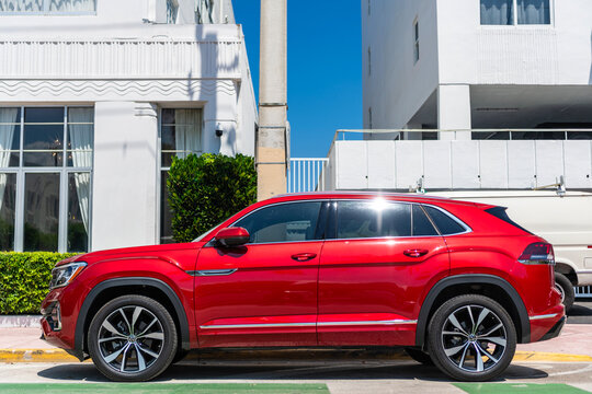Miami, Florida, USA - May 13, 2025: Volkswagen Atlas or Atlas Cross Sport 2024 crossover SUV car. Luxury crossover car Volkswagen Atlas. Car Volkswagen Atlas parked outdoor. Red car, side view.