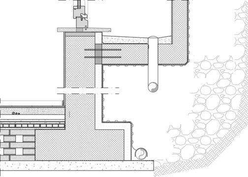 Technical CAD section detail of a civil engineering structure showing a concrete retaining wall with a vertical drainage pipe, reinforcement bars, and a riprap rock fill area.