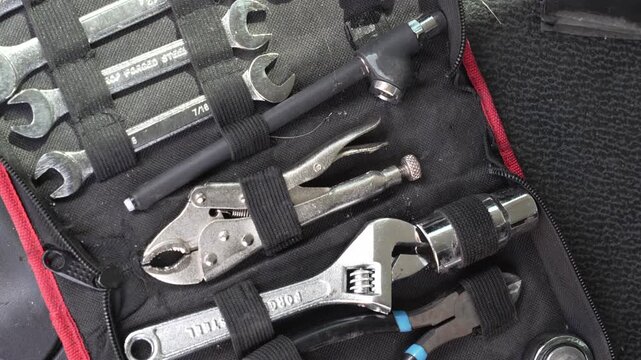 A tool case displaying assorted wrenches and pliers, neatly organized for mechanical work video