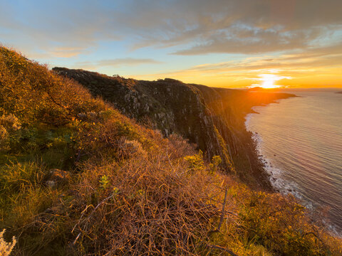 Epic sunrise golden light on the Waitpinga Cliffs at dawn over the ocean and horizon on the Fleurieu Peninsula in South Australia
