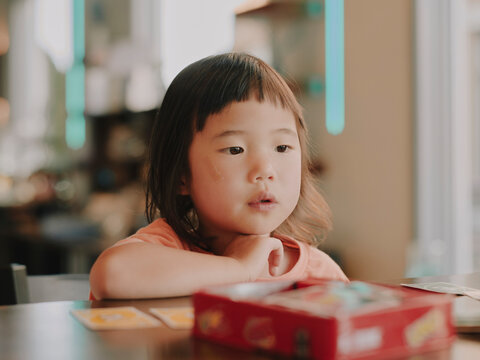 little girl playing card game