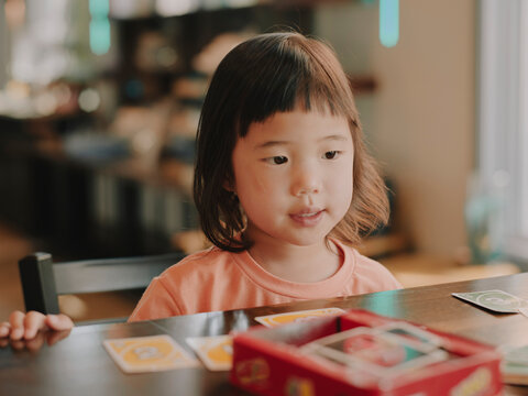 little girl playing card game