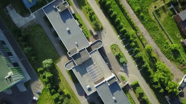 Top down drone flies over hospital roofs
