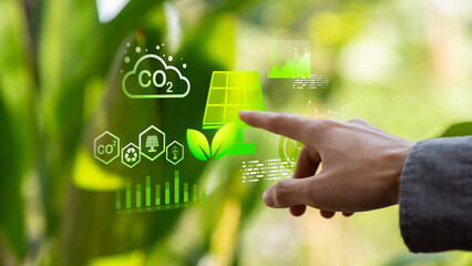 A sustainability consultant uses green technology analytics to evaluate solar energy, carbon reduction, renewable power, ESG , net zero goals, and climate investment for sustainable business growth. © Nichaphat