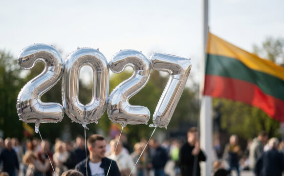 Silver foil balloons forming the number 2027 at a festive public outdoor celebration event