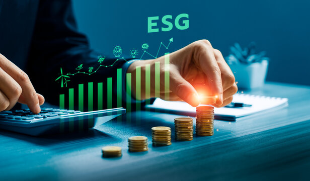 ESG investment concept with hand stacking coins, calculator and rising green chart showing sustainable finance, environmental strategy, responsible growth and business performance