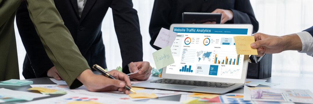 Analyst team use sticky note for creative and analytic brainstorm for business idea with BI data dashboard on laptop screen. Analysis financial data visualization tech for marketing strategy. Prodigy