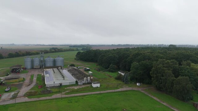 Livestock Barn and Grain Silos Beside Forest on Ruegen Drone View