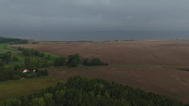 Farmhouse Between Forest and Plowed Fields on Ruegen Aerial View Heavy Rain Stormy Weather