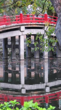 Taiko Bridge in Dazaifu Tenmangu shrine complex, Dazaifu City, Fukuoka Prefecture, Taiko-bashi arched red bridge with reflection in pond, Kyushu Island, Japan, traditional Japanese architecture
