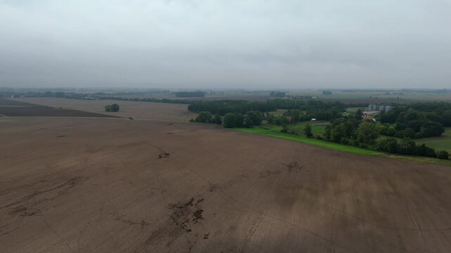 Plowed Field and Treeline Under Overcast Sky Ruegen Drone View
