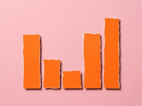Minimalist Bar Chart Made of Torn Orange Paper on a Pink Background