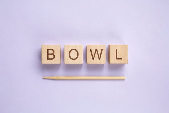Bowl Word Spelled with Wooden Blocks on Pastel Background