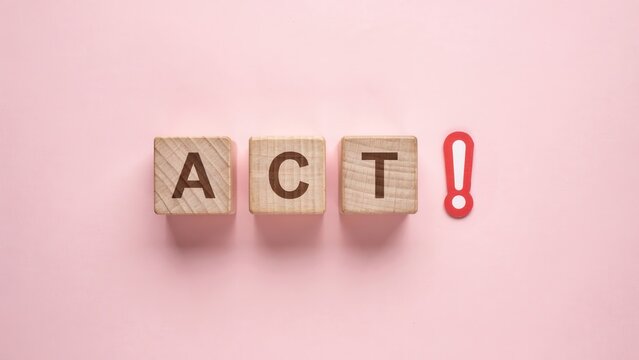 ACT word on wooden blocks with exclamation mark, motivational concept on pink background, call to action business message, proactive decision making