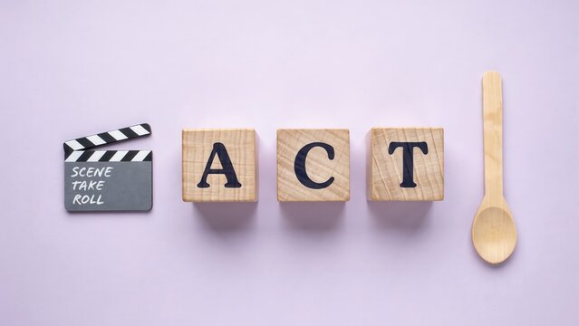 ACT word on wooden blocks with movie clapperboard and spoon, acting and performance concept on purple background, creative theater and film industry still life