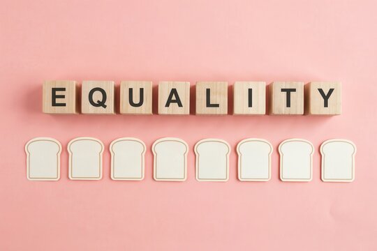 Equality concept on wooden blocks, social justice message on pink background, human rights and fair treatment conceptual photo