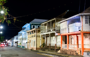 Obraz premium Traditional wooden colonial buildings illuminated at night on West Independence Street in Basseterre, Saint Kitts and Nevis.