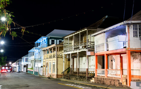 Traditional wooden colonial buildings illuminated at night on West Independence Street in Basseterre, Saint Kitts and Nevis.