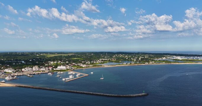 New Shoreham, RI USA - August 12, 2026 - Morning aerial video, panning left to right, of Block Island's Old Harbor and Crescent Beach on a sunny summer day, 4096 x 2160, Frame rate 29.97 fps.