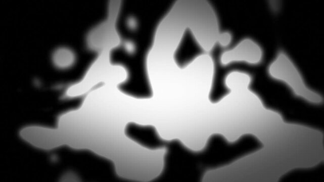 Abstract monochrome liquid morphing backdrop with flowing organic shapes on a dark background.
