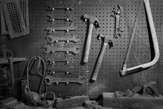 old rusty tools on wood in toolshed