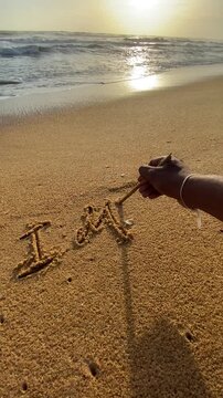 I Miss You Message in Beach Sand with Approaching Ocean Waves