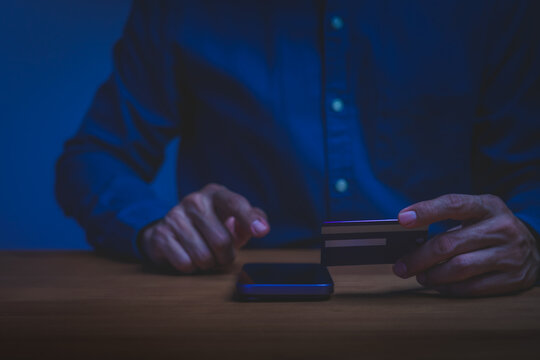 Man holding credit card and using smartphone for online shopping and digital payment. Concept of e-commerce, mobile banking, internet finance, and business purchase transaction.